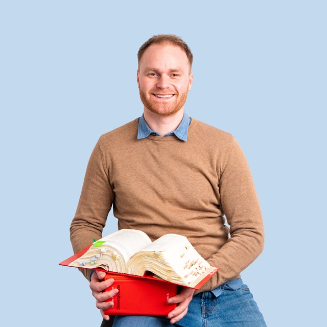 Mann mit einer Kiste voller Gesetzbücher